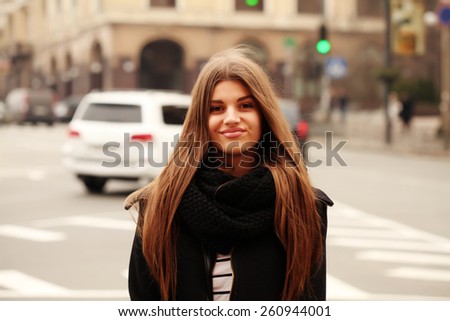 Portrait of beautiful girl outdoors. Young hipster woman in the city traffic