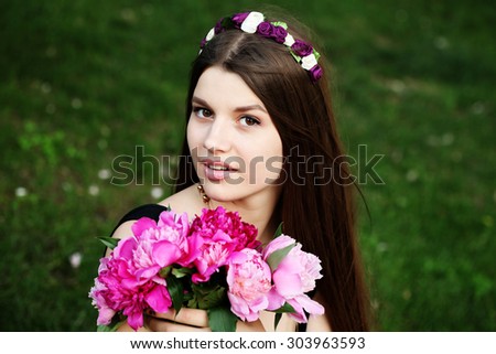 Beautiful woman in flower headband outside. Young fashionable hippie girl outdoor. Enjoy nature. Laughing and happy.