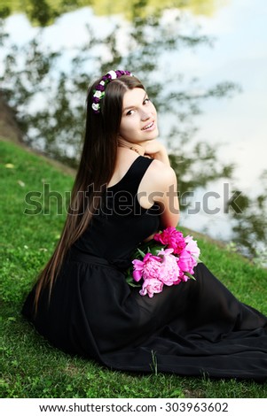 Beautiful woman in flower headband outside. Young fashionable hippie girl outdoor. Enjoy nature. Laughing and happy.