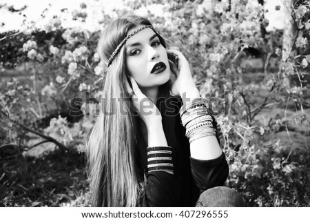 Beautiful bohemian girl in spring garden. Black and white photo of beautiful woman
