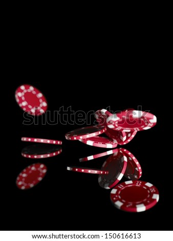 Studio shot showing falling poker chips isolated on black background.