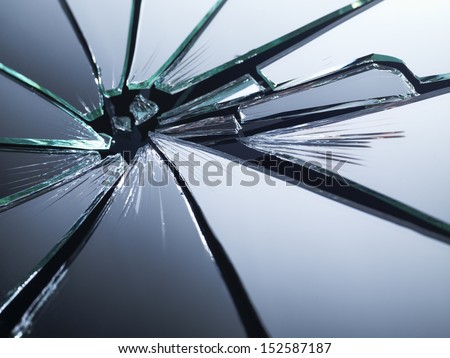 Broken mirror shattered in many pieces.