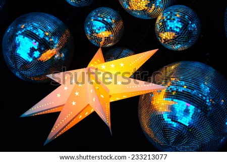 Nightclub disco balls and glowing star in colorful festive lights in dance club