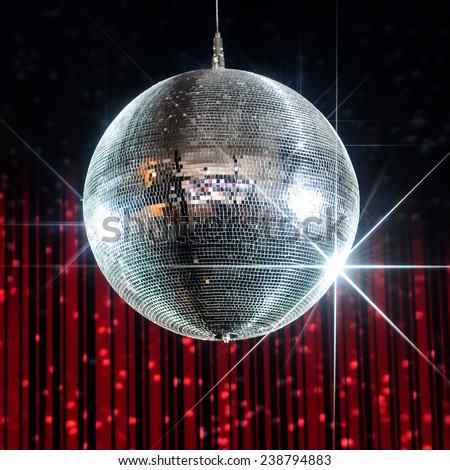 Silver disco ball with stars in nightclub with striped red and black walls