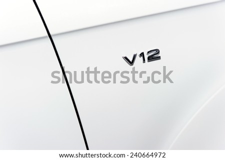 Engine v12. Front fender of sport white car side with powerful motor.