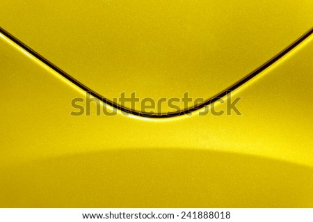 Smooth curves of bright yellow metal car body. Abstract - steel post envelope.