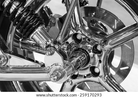 Front wheel of high power big custom motorcycle with chrome parts - monochrome, blurred selective focus