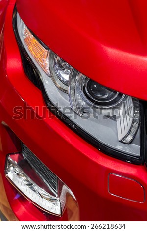 Headlight with led lamps and hood of red sport modern car