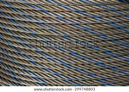 Steel rope coil, iron cable, wire of grey, blue and gold colors, hawser abstract texture, industrial background
