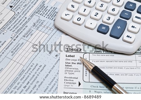 Income Tax Logo. income tax forms with pen
