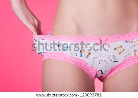 Young woman holding panties