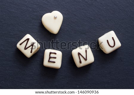 White chocolate candies with menu text