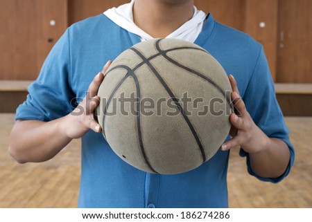 Basketball on the chest, in the indoor basketball court.