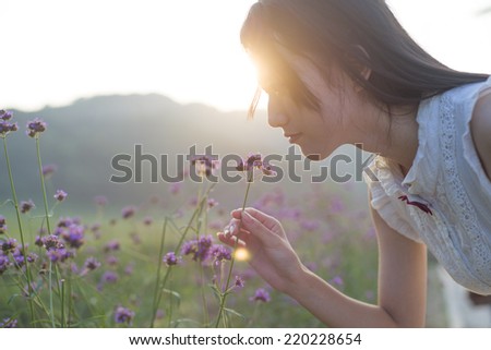 Girl smelling flower fragrance