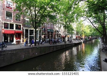 AMSTERDAM, THE NETHERLANDS - JULY 17: Canal in the red-light district on July 17, 2010 in Amsterdam, The Netherlands.