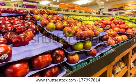 MADISON, NJ, USA - FEBRUARY 13, 2014: Shelf with apples in an American supermarket.  The shift to simpler diets, based on fruits and vegetables, has helped to stabilize obesity levels in USA.