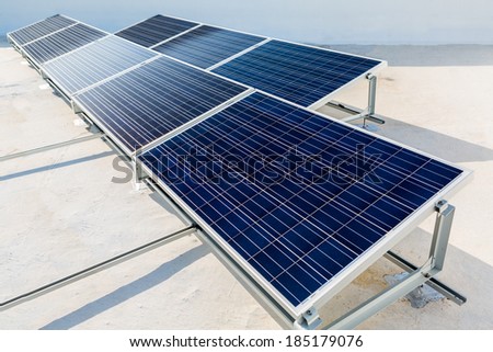 Solar panels standing on a rooftop under a bright sunny day