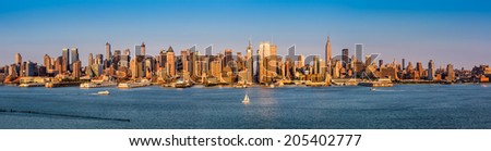 New York City Panorama. The last sun rays before sunset cast an orange glow on the skyscraper\'s facades