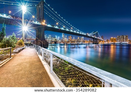 Manhattan Bridge by night, viewed from John Street Park with Brooklyn Bridge and Lower Manhattan skyline in the background.