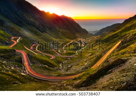 Traffic trails on Transfagarasan pass at sunset. Crossing Carpathian mountains in Romania, Transfagarasan is one of the most spectacular mountain roads in the world.