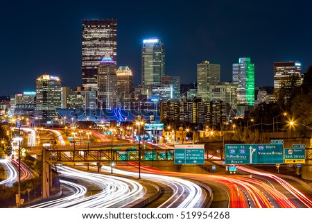 Pittsburgh skyline by night. The rush hour traffic leaves light trails on I-279 parkway