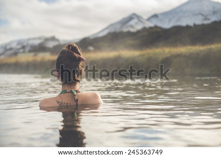 Girl in a hot spring in Iceland Landmannalaugar