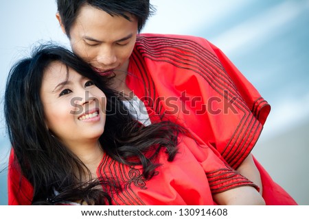 An in love young couple in romantic emotion with similar red dress