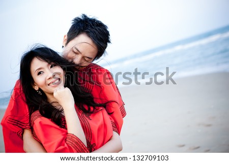 An in love young couple in romantic emotion with similar red dress