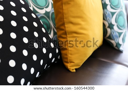 Colorful pillows on leather sofa