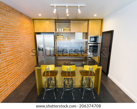 Stylish modern contemporary kitchen with island bar, chair and home appliances