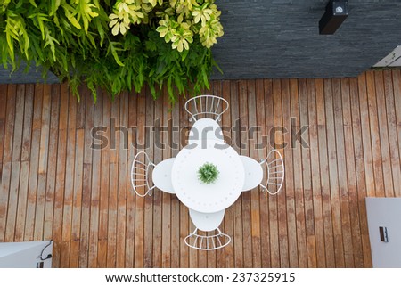 Vintage outdoor coffee table in cafe wooden terrace
