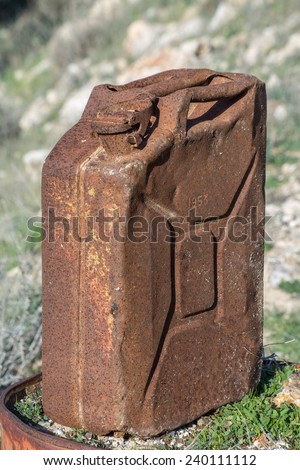 old rusty gas can( jerry can)  in the field, produced in 1953