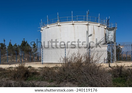 water tank surrounded by a fence