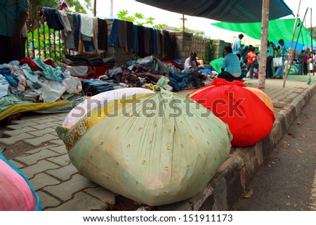 BANGALORE, INDIA - AUGUST 25: The bundle of new cloth items coming from the factory and waiting for the sellers to be displayed  on August 25, 2013 in Madiwala market in Bangalore, India.
