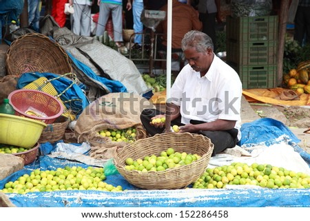 BANGALORE, INDIA - AUGUST 25: Unidentified vender  selling lemon on a city street on August 25, 2013 in Madiwala market, Bangalore, Karnataka, India.
