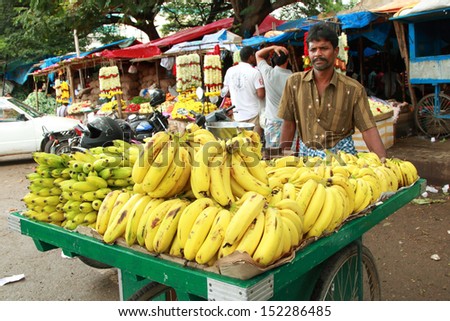 BANGALORE, INDIA - AUGUST 25: Unidentified street seller  selling banana on a city street on August 25, 2013 in Madiwala market, Bangalore, Karnataka, India.