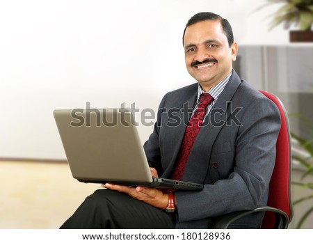 Senior Indian business man using laptop