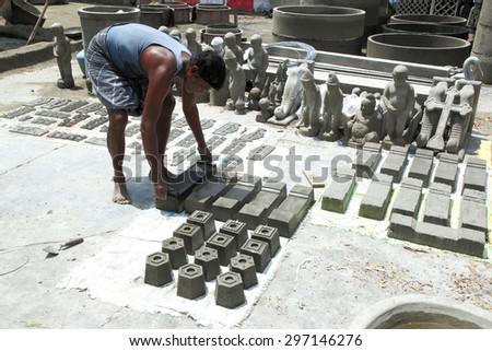 TENKASI,TAMILNADU - MARCH 31, 2015: Unidentified man doing job in his workshop of  cement sculpture at Tenkasi,Tamilnadu,South India  on march 31 2015.