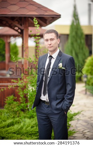 groom man in park man in suite wedding