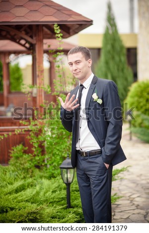 groom man in park man in suite wedding
