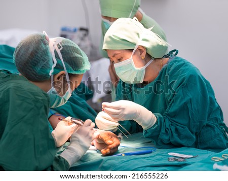 young female surgeon doing operation
