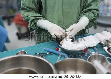 scrub nurse prepare medical instruments for open heart surgery