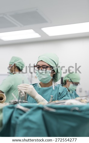 scrub nurse preparing medical instruments for  surgery