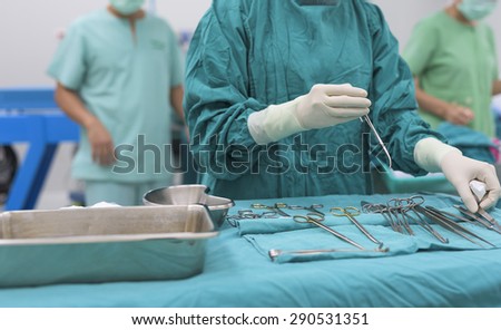 scrub nurse team preparing tools for operation