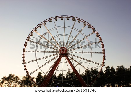 Vintage Retro Ferris Wheel on Blue Sky.  Front view. Ferris Wheel at amusement park