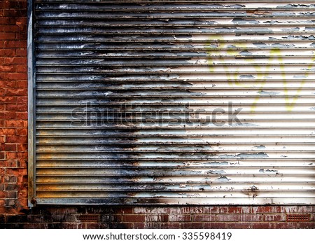 Background/ wallpaper -  old store front - metal shutter and brick wall.