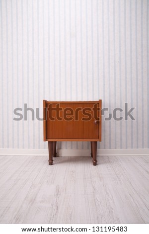 old fashioned little piece of furniture on an old style background