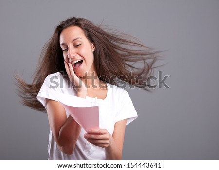 Passionate young woman falling in love reading a pink love letter
