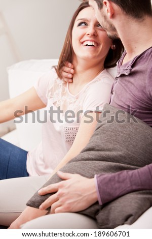 couple falling in love because she\'s looking at him with love while he holds her in his arms