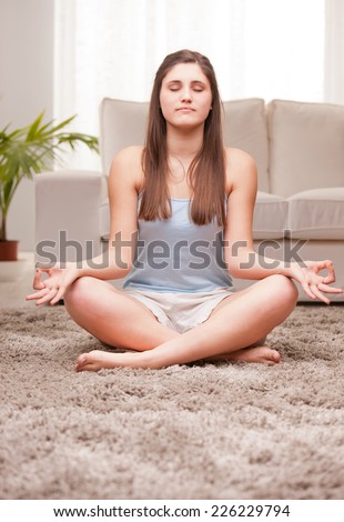 young woman preparing for her yoga exercises
